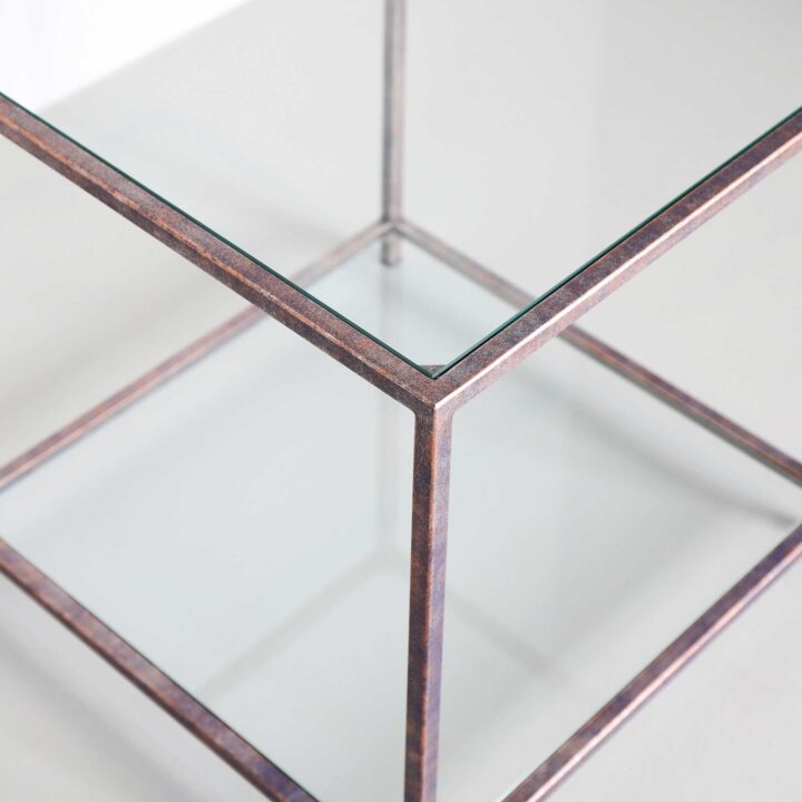 Finished in "Sunset Blue" with a clear glass top and shelf