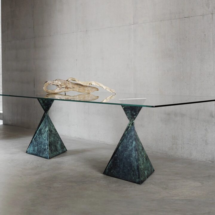 Made in bronze with a "Bottle Green" patination, polished bronze top plates and a clear glass top