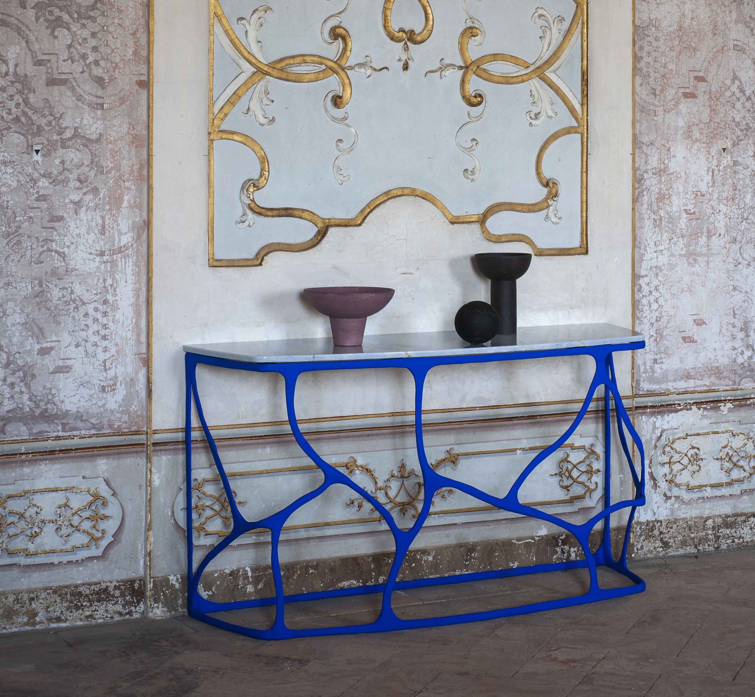 Boulder console covered in papier mâché finished in Yves Klein blue with a marble top