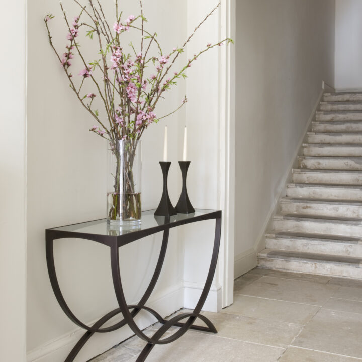 Fitzroy console finished in ‘Bronze’ with a clear glass top + Capricorn candlesticks finished in ‘Bronze’