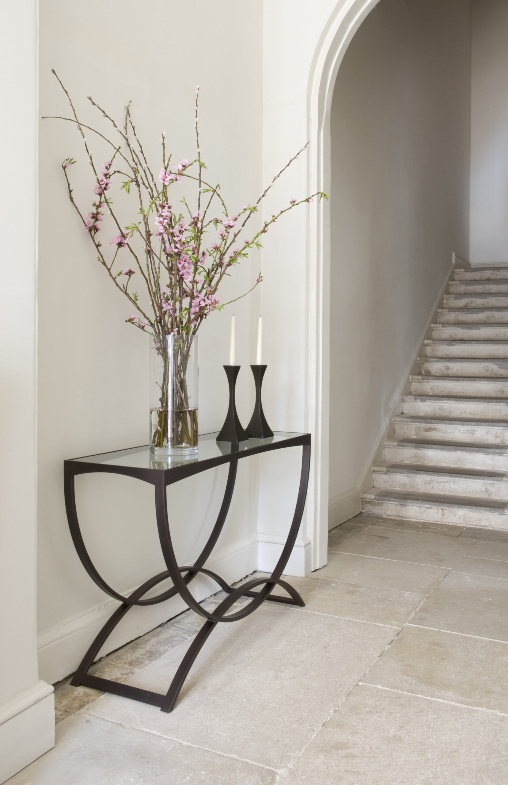 Fitzroy console finished in ‘Bronze’ with a clear glass top + Capricorn candlesticks finished in ‘Bronze’