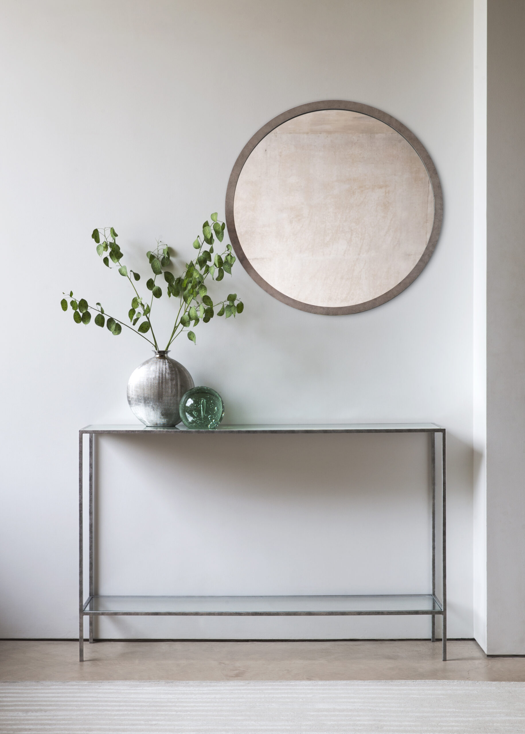Madison round mirror finished in ‘Burmese Red’ + Lexington console finished in ‘Antique Silver’ with a Silver Leaf verre eglomise top