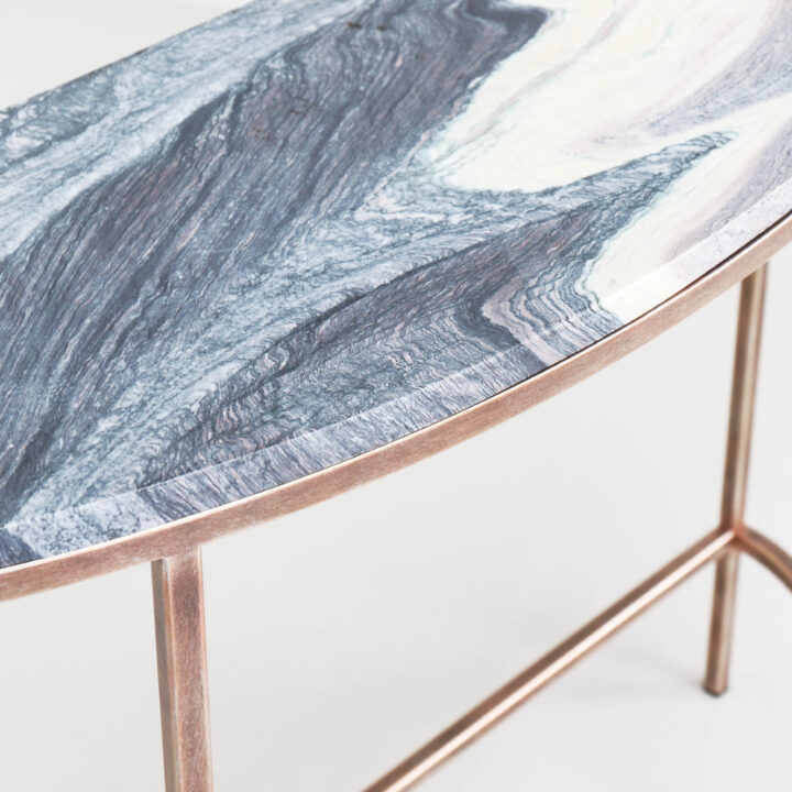Finished in Rose Pewter with a Rosso Luana marble top