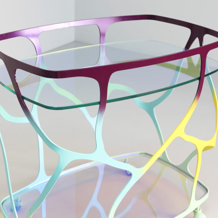 Finished in "Macheon" with a dichroic glass top and shelf
